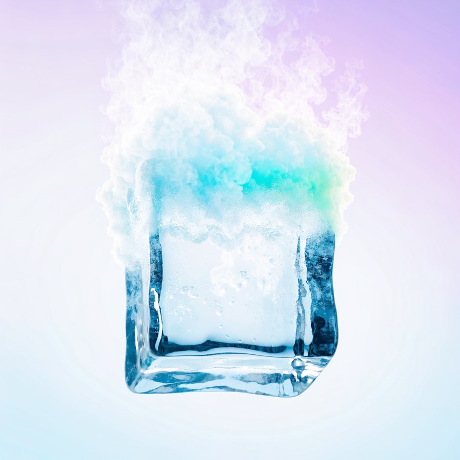 A cube of ice turning directly into vapour, its upper half dissolving into mist